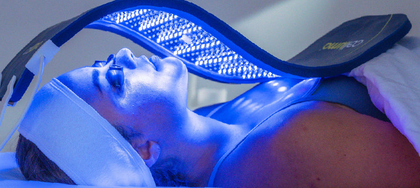 Woman using blue light therapy for acne treatment