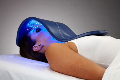 Led light therapy used by woman for acne treatment