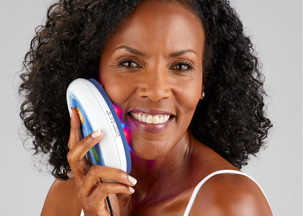 Woman using LED device for pigmentation