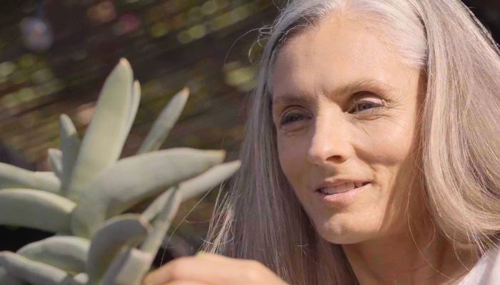 Woman standing in front of succulent plant