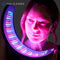 Woman holding an FDA-cleared Celluma NOVA led low-level light therapy device with multi-wavelength technology utilizing red light, near-infrared light, and blue light energy.