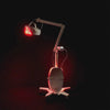 The Celluma ELITE series 2 professional red light therapy machine being used on CONTOUR mode for body contouring.  Image shows the machine's mobile base, flexible arms and rotating panel.